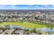 Vast aerial panorama of a residential area, boasting ponds, a golf course, and a large selection of single-Gathering houses at 3629 Pete Dye Blvd, Carmel, IN 46033