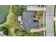Birds-eye view of a home's backyard featuring an outdoor deck and patio, nestled among lush green trees and a pond at 3629 Pete Dye Blvd, Carmel, IN 46033