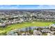 Expansive aerial view of a neighborhood with a golf course and a lake community on a clear, sunny day at 3629 Pete Dye Blvd, Carmel, IN 46033