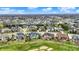 Panoramic aerial shot capturing a community with ponds, mature trees, and diverse housing options, set amidst green spaces at 3629 Pete Dye Blvd, Carmel, IN 46033