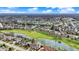 Extensive aerial view showcasing a neighborhood with ponds, golf courses, and a diverse collection of residential properties at 3629 Pete Dye Blvd, Carmel, IN 46033