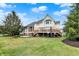 Expansive backyard featuring a wooden deck, lush lawn, and mature trees, perfect for outdoor living at 3629 Pete Dye Blvd, Carmel, IN 46033