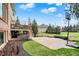 Large backyard with basketball court, landscaping, and a wooden deck, ideal for relaxing and entertaining at 3629 Pete Dye Blvd, Carmel, IN 46033