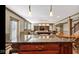 Spacious basement showcases kitchenette, billiard table, living area, and stairs, ideal for entertaining and relaxation at 3629 Pete Dye Blvd, Carmel, IN 46033
