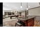 Large basement features a kitchenette, billiard table, and seating area with a staircase for easy access at 3629 Pete Dye Blvd, Carmel, IN 46033