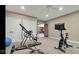 Home gym with various workout equipment, mounted TV, and access to other rooms at 3629 Pete Dye Blvd, Carmel, IN 46033