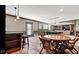 Entertaining basement with billiards table, lounge area, bar seating, and modern lighting at 3629 Pete Dye Blvd, Carmel, IN 46033