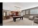 View of basement featuring a billiards table, seating area, and kitchenette with dark wood cabinets at 3629 Pete Dye Blvd, Carmel, IN 46033
