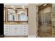 Bathroom features a white vanity with granite counters, large mirror, tile floors, and a walk-in shower at 3629 Pete Dye Blvd, Carmel, IN 46033