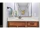 This bathroom has a wooden vanity with a marble countertop, modern mirror, and unique wall art at 3629 Pete Dye Blvd, Carmel, IN 46033