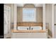 Soaking tub with tile surround, framed by decorative columns, under a patterned glass window at 3629 Pete Dye Blvd, Carmel, IN 46033
