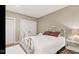 Bedroom featuring a white iron bed frame, plush carpet, and a charming side table with decorative lamp at 3629 Pete Dye Blvd, Carmel, IN 46033