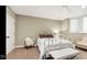 Bright bedroom with a white iron bed frame, carpeted floors, and a classic window, creating a cozy retreat at 3629 Pete Dye Blvd, Carmel, IN 46033