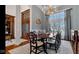 Formal dining room with a large window, elegant chandelier, and dining set, perfect for gatherings at 3629 Pete Dye Blvd, Carmel, IN 46033