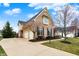 Side angle of home with a three car garage and beautiful landscaping at 3629 Pete Dye Blvd, Carmel, IN 46033