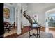 Grand foyer with hardwood floors, decorative columns, elegant furnishings, and a view of the staircase at 3629 Pete Dye Blvd, Carmel, IN 46033
