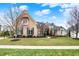 Beautiful home with a well-manicured lawn, elegant brickwork, and lush landscaping in a peaceful neighborhood at 3629 Pete Dye Blvd, Carmel, IN 46033