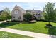 Beautiful brick home with a manicured front yard, mature trees, and attractive landscaping at 3629 Pete Dye Blvd, Carmel, IN 46033