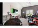Entertainment room features a geometric wall, TV, shelves, and an array of gaming accessories at 3629 Pete Dye Blvd, Carmel, IN 46033