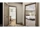 Hallway view into bedroom and bathroom, highlighting travertine tile, and complementing the open design at 3629 Pete Dye Blvd, Carmel, IN 46033