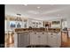 Open-concept kitchen with stainless steel appliances, granite countertops, and view of a spacious living area at 3629 Pete Dye Blvd, Carmel, IN 46033