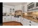 Elegant kitchen with stainless steel appliances, custom cabinetry, and stone backsplash, perfect for cooking enthusiasts at 3629 Pete Dye Blvd, Carmel, IN 46033