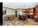 Includes a stylish island with seating, custom cabinets, and stone flooring, offering a functional and attractive space at 3629 Pete Dye Blvd, Carmel, IN 46033