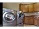 Functional laundry area equipped with a sink, modern appliances, and plenty of storage at 3629 Pete Dye Blvd, Carmel, IN 46033