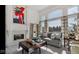 Bright living room with a decorative fireplace, large windows, and comfortable seating arrangements at 3629 Pete Dye Blvd, Carmel, IN 46033