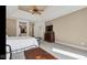 Comfortable main bedroom featuring a ceiling fan, dresser, and access to the main bathroom at 3629 Pete Dye Blvd, Carmel, IN 46033