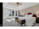 Spacious main bedroom featuring large windows, a tray ceiling, and stylish furnishings at 3629 Pete Dye Blvd, Carmel, IN 46033
