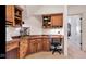 Bright office features wood cabinets, desk, neutral walls, and carpet with a glimpse of an adjoining space at 3629 Pete Dye Blvd, Carmel, IN 46033