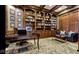 Beautiful office featuring custom built-in bookshelves, a large desk, and a comfortable sofa at 3629 Pete Dye Blvd, Carmel, IN 46033