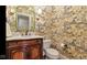 Detailed powder room featuring unique wallpaper, a wood vanity, and a modern toilet at 3629 Pete Dye Blvd, Carmel, IN 46033