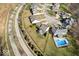 Overhead view of an upscale neighborhood with manicured lawns, a pool, and tree-lined streets at 368 Westbrook Ct, Columbus, IN 47201