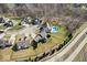 Drone shot of homes in a suburban area with manicured lawns, mature trees, and a community pool at 368 Westbrook Ct, Columbus, IN 47201