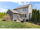 Expansive backyard with patio, screened porch, and lush landscaping at 368 Westbrook Ct, Columbus, IN 47201