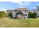 View of the back of the house featuring a large yard and screened porch at 368 Westbrook Ct, Columbus, IN 47201