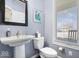Powder room featuring a pedestal sink, framed mirror, and light gray walls at 368 Westbrook Ct, Columbus, IN 47201