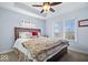 Bright bedroom features a ceiling fan, tray ceiling and large windows at 368 Westbrook Ct, Columbus, IN 47201