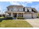 Charming two-story home featuring a covered front porch, well-maintained lawn, and an attached three car garage at 368 Westbrook Ct, Columbus, IN 47201