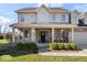 Inviting entrance with a covered porch, lush landscaping, and a welcoming front door with decorative wreath at 368 Westbrook Ct, Columbus, IN 47201