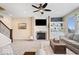 Cozy living room with a fireplace, built-in shelving, plush carpeting, and plenty of natural light at 368 Westbrook Ct, Columbus, IN 47201