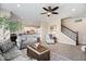 Bright living room with cozy seating, open to the modern kitchen and staircase at 368 Westbrook Ct, Columbus, IN 47201