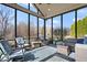 Bright sunroom with comfortable seating and patterned rug overlooking backyard at 368 Westbrook Ct, Columbus, IN 47201