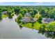 Aerial view of a lakeside home with a backyard deck, showcasing the property's private and picturesque setting at 3862 Penzance Pl, Carmel, IN 46032