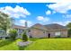 Backyard showcases a well-maintained lawn and serene pond, enhanced by mature trees creating a private outdoor retreat at 3862 Penzance Pl, Carmel, IN 46032