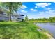 Lush backyard extends to a tranquil lake, providing a serene backdrop for the home and its outdoor deck at 3862 Penzance Pl, Carmel, IN 46032