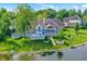 A beautiful backyard includes a spacious deck and lush landscaping, creating a private oasis by the lake at 3862 Penzance Pl, Carmel, IN 46032