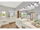 Primary bathroom featuring double sink vanity, makeup counter, walk-in shower and soaking tub with view at 3862 Penzance Pl, Carmel, IN 46032